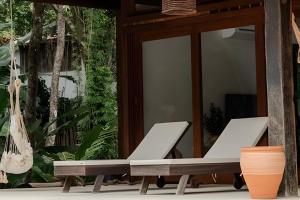 two chaise lounges on the porch of a house at Casas Versos do Mar in Marau