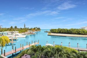 a view of a marina with boats in the water at Oceanfront 5BR+ Bonus Room•75’ Dock •Pool-Spa •Kids area •Walk to Sombrero Beach in Marathon