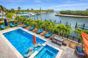 an infinity pool at the resort with a view of the water at Oceanfront 5BR+ Bonus Room•75’ Dock •Pool-Spa •Kids area •Walk to Sombrero Beach in Marathon