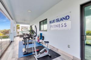 a gym with two tread machines and a sign that reads blue island fitness at Oceanfront 5BR+ Bonus Room•75’ Dock •Pool-Spa •Kids area •Walk to Sombrero Beach in Marathon
