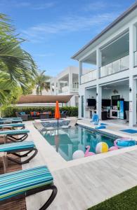 an image of a villa with a swimming pool at Oceanfront 5BR+ Bonus Room•75’ Dock •Pool-Spa •Kids area •Walk to Sombrero Beach in Marathon