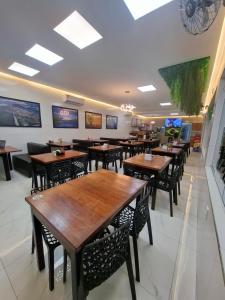 a dining room with wooden tables and chairs at Pousada Flor de Sal in Macau
