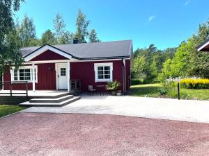 a red and white house with a patio at Linnearo in Mariehamn