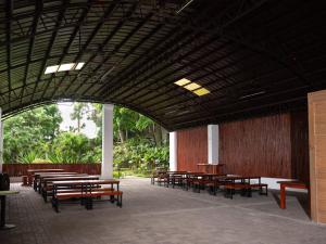a group of tables and benches in a building at The Glens Tagaytay in Kaybagal