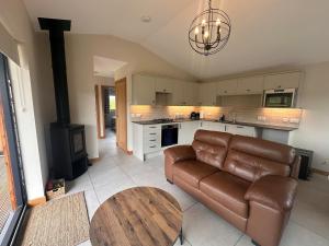 a living room with a couch and a table at Sputieburn Bothy in Brora