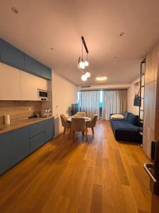a kitchen and living room with a table and a couch at VOGH Olimp Premium Sea View Escape in Olimp