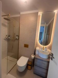 a bathroom with a toilet and a sink and a shower at VOGH Olimp Premium Sea View Escape in Olimp
