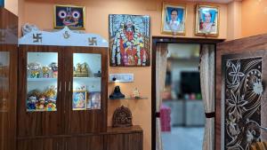 a room with a cabinet filled with religious items at Swapna-Nir in Howrah
