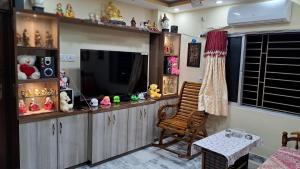 a living room with a television and a chair at Swapna-Nir in Howrah