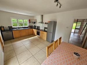 a kitchen with a table and a kitchen with a refrigerator at Letterkenny View in Letterkenny