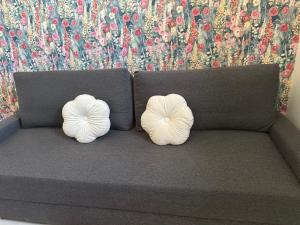 two white pillows sitting on top of a couch at Prince in Perrigny-lès-Dijon