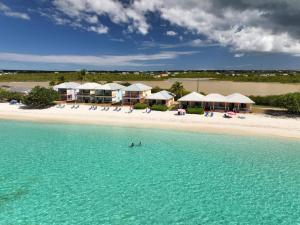 a person swimming in the water on a beach at Rendezvous Bay Hotel in Lower South Hill