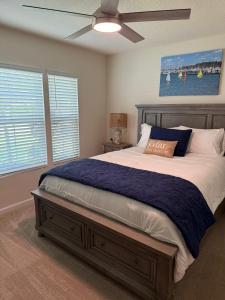 a bedroom with a large bed with a ceiling fan at Rybark Manor in Palm Coast