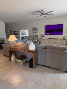 a living room with a couch and a tv at Rybark Manor in Palm Coast