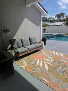 a couch sitting on a rug next to a pool at Rybark Manor in Palm Coast