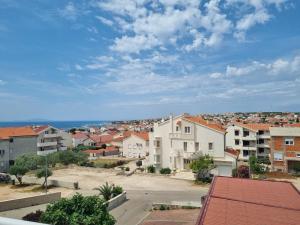 Blick auf eine Stadt mit Gebäuden und dem Meer in der Unterkunft View - Novalja in Novalja