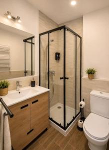 a bathroom with a shower and a toilet and a sink at Villa Rural in Cabezuela +24 photos