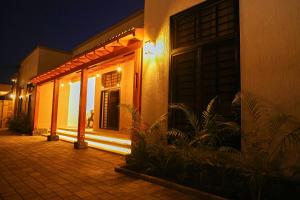 a house with a lit up door at night at Villa Maisha in Arusha