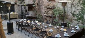 a tables and chairs with bowls and cups on them at LA CASITA in Buenos Aires