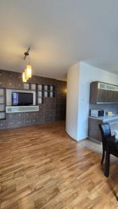 an empty living room with a table and a television at Kościuszki Centrum Apartment in Łódź