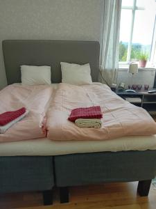 a large bed with two pillows on top of it at Lantgårdshotellet in Tälje