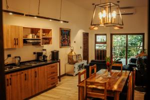 a kitchen and living room with a wooden table at Samaya Wellness Lodge in Flores