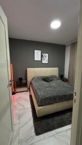 a bedroom with a bed and two pictures on the wall at Casa Mo in Akouda