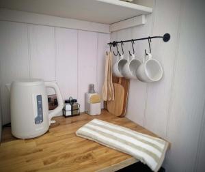 a kitchen counter with a coffee maker and utensils at Stone Cottage Relax & Unwind, Cosy Cinema Retreat in Laurencekirk