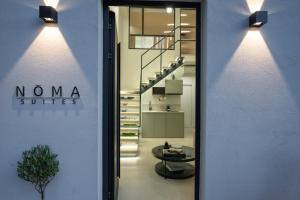 a hallway with a staircase and a table in a building at NOMA Suites in Kalamata