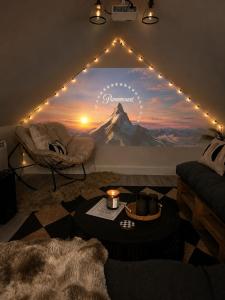 a living room with a large mural of a mountain at Stone Cottage Relax & Unwind, Cosy Cinema Retreat in Laurencekirk