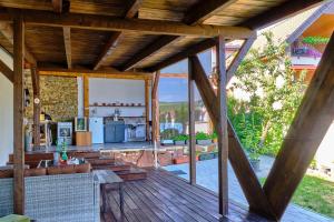 a wooden deck with a kitchen and a living room at Villa Axa in Vrbov
