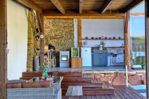 an outdoor kitchen in a house with a stone wall at Villa Axa in Vrbov