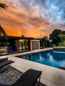 a swimming pool in front of a house at CasaKadd Grand Escape in Civé