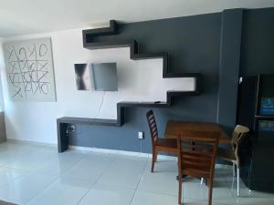 a dining room with a staircase and a table and chairs at Hermoso Departamento Ejecutivo 2 in Guadalupe +4 photos