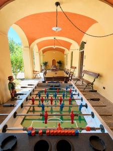 a pool table with figurines on it in a room at Apartment La Bigatera in Castelveccana