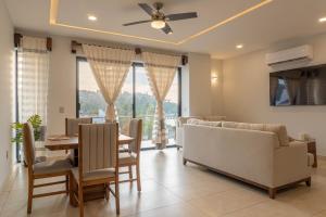 a living room with a dining table and a couch at EOS Suites in Santa Cruz Huatulco