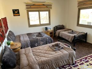 a living room with two beds and a couch at Eman house in Wadi Musa