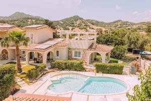 an aerial view of a house with a swimming pool at Lentischi Hotel - Adults Only in Villasimius
