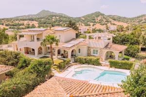 an aerial view of a house with a swimming pool at Lentischi Hotel - Adults Only in Villasimius
