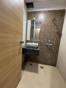 a bathroom with a sink and a mirror at V studio in Ghaziabad