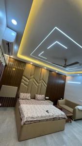 a bedroom with a large bed and a couch at V studio in Ghaziabad