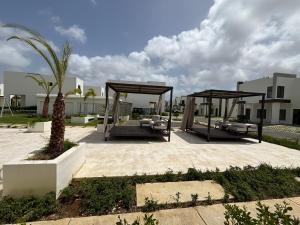 a park with two benches and a pavilion at Eco Avalon Paradise Villa in Punta Cana