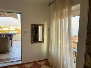 a room with a window with a view of the ocean at Apartments Tati in Ulcinj