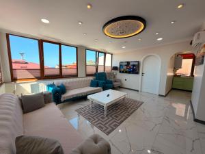 a large living room with a couch and a table at Çakır Residence in Trabzon