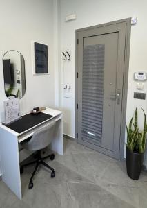 a office with a desk and a mirror and a door at Date Palm Studio in Kremasti
