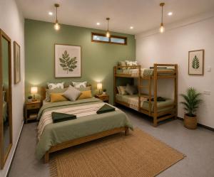 a bedroom with a bed and two bunk beds at Arcadia villas Arugambay in Arugam Bay