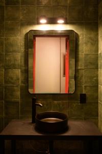 a bathroom with a sink and a mirror at Macarena Hostel in Flores