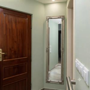 a bathroom with a mirror and a wooden door at Stefanos house in Parga +28 photos