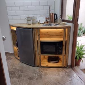 a kitchen with a microwave and a sink at Stefanos house in Parga