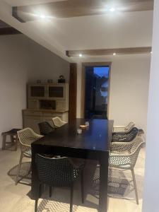 a dining room with a black table and chairs at Castle view Chalet - ZemvaStays in Zgornje Gorje
